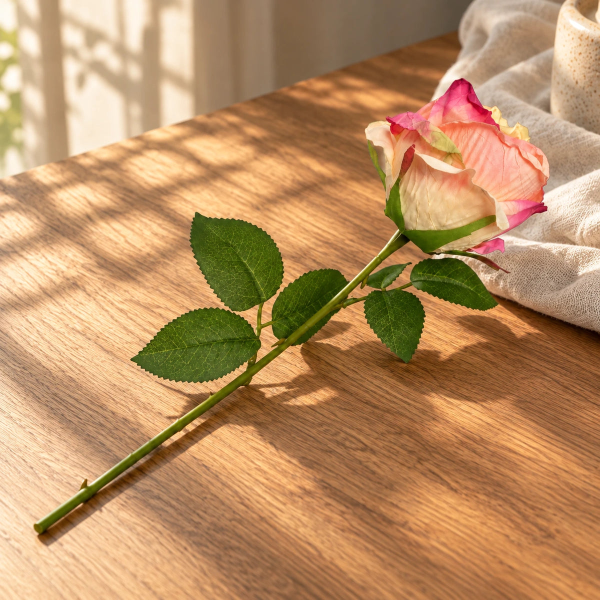 Artificial tea rose in a styled display