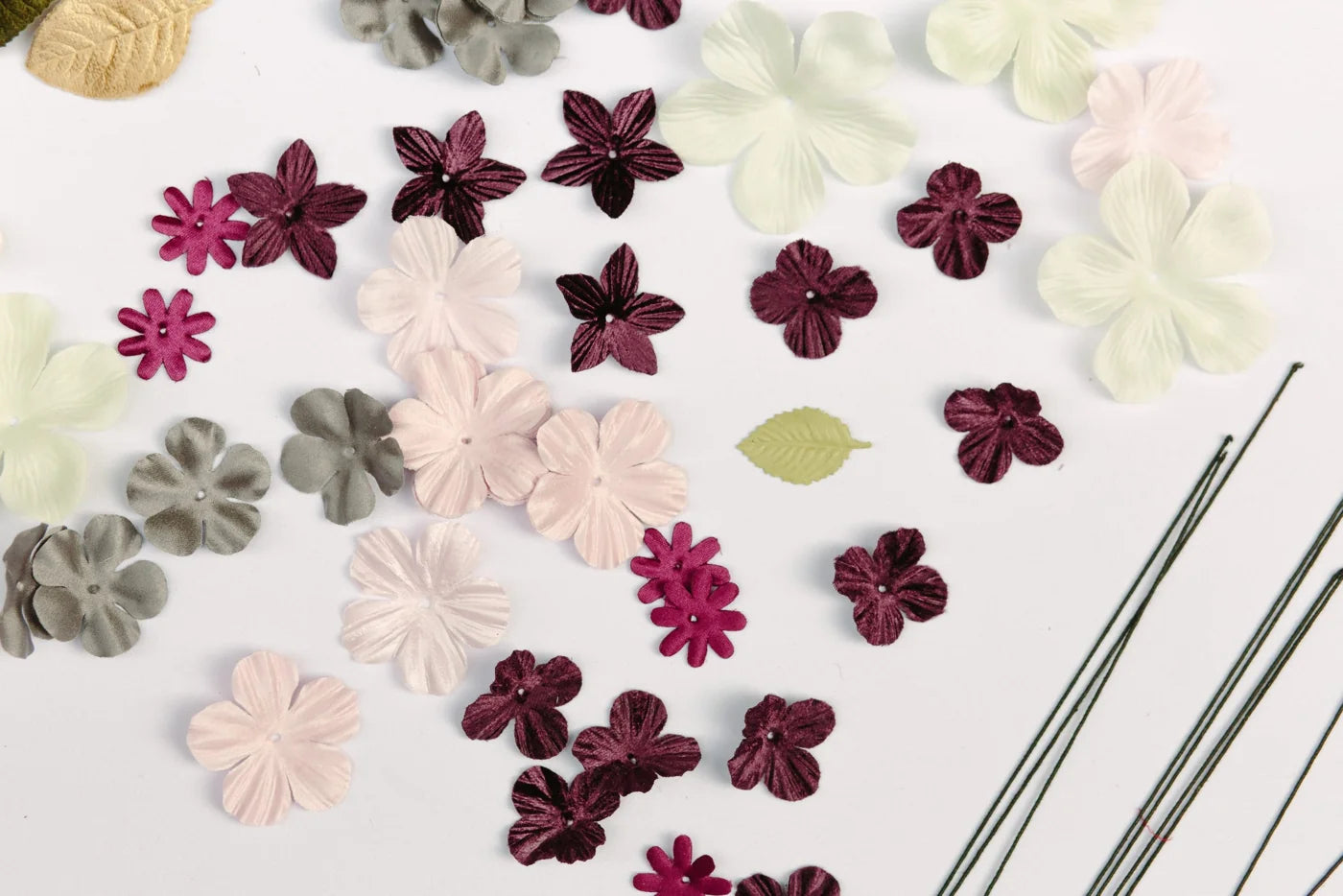 Industry reference: cut artificial flower components laid out for comparison