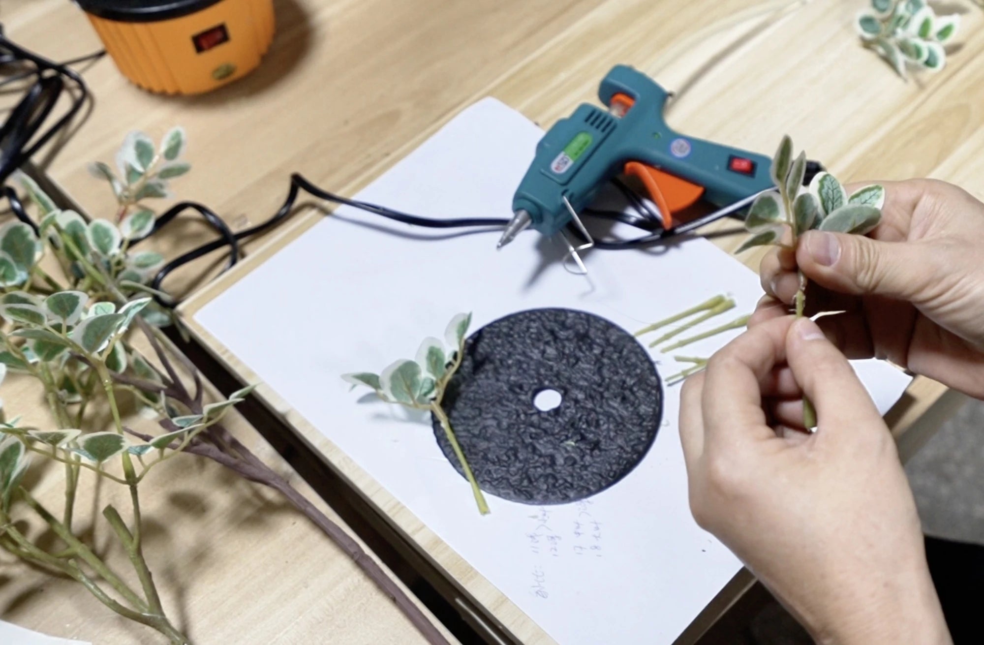 Artificial foliage assembly with tools and workbench